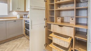 A kitchen with cabinets, a toaster, and a kettle. - Deluxe Lodge, parking, ensuite, decking & sea view (Ryde, Nr Bembridge)
