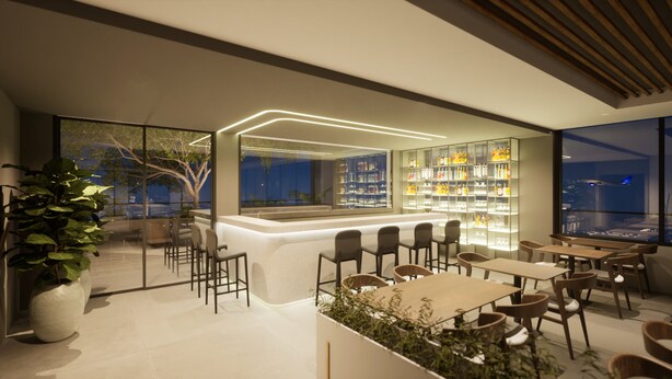A modern bar area with a counter, seating, and shelves stocked with bottles. - Laghetto Stilo Aeroporto (Porto Alegre)