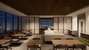 A modern dining area with wooden tables and chairs, large windows, and a view of the cityscape. - Laghetto Stilo Aeroporto (Porto Alegre)