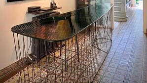 A modern interior with a bar area, a large abstract painting, and a staircase leading to an upper level. - The Piano Guesthouse - Kwaadham 52 (Ghent)