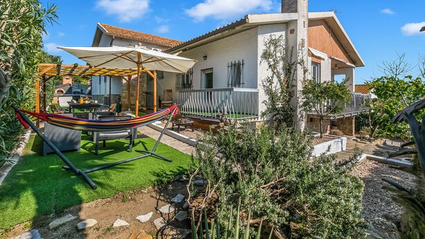 A house with a balcony, a hammock, and a patio area. - Villa Talamone With Beautiful Sea View (Orbetello)