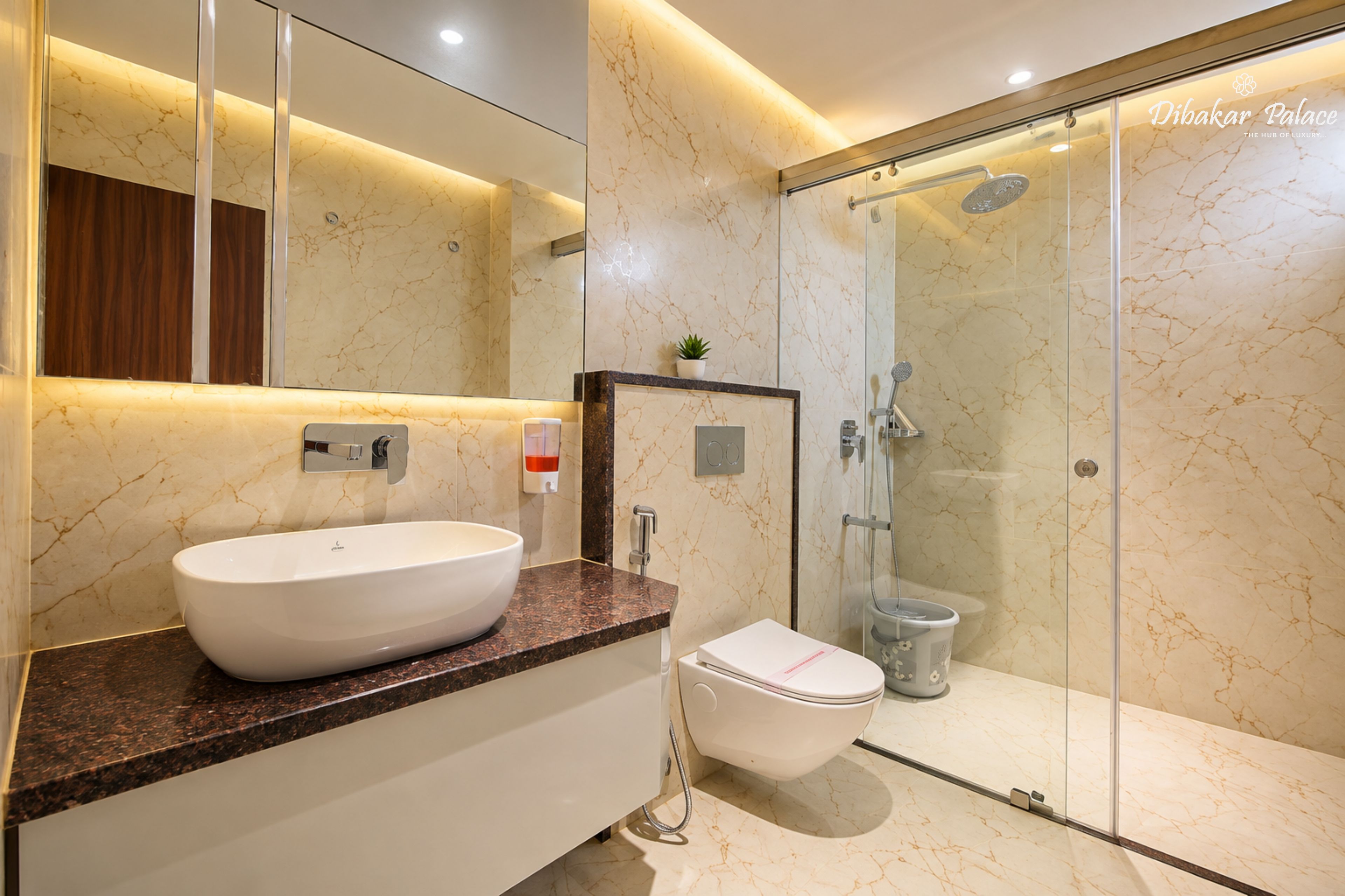 A modern bathroom with a large mirror, a white sink, a toilet, and a glass-enclosed shower area.