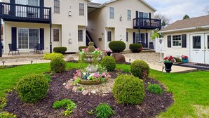 A two-story residential building with a balcony, a garden with a flower bed, and a laundry facility. - “Friends” Central Perk- Fun Escape - Starved Rock- Ottawa (Ottawa)