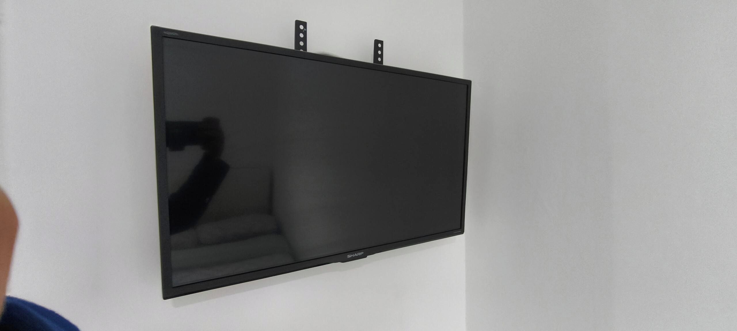 A flat-screen TV mounted on a wall.