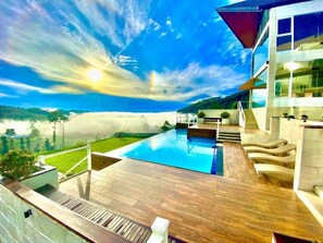 A modern house with a swimming pool, a deck, and a view of the mountains. - Hilldale Retreat (CP)