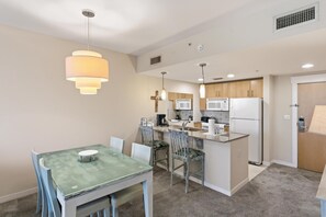 A compact kitchen with a dining area, featuring a central island, built-in appliances, and pendant lighting. - One Bedroom Condo in Elation at Sandestin Golf and Beach Resort (Miramar Beach)