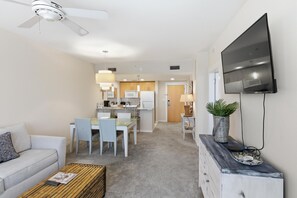 A modern living room with a sofa, coffee table, and TV. - One Bedroom Condo in Elation at Sandestin Golf and Beach Resort (Miramar Beach)
