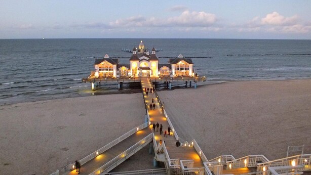 A beachfront hotel with a central building, a pier extending into the sea, and a walkway leading to the beach. - 4 Star Holiday Home in Sagad (Sagard)