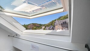 A skylight window with a view of buildings and a sign indicating a room feature. - Duplex in Carolles, Bay of Mont Saint Michel, 50 m from the Beach (Carolles)