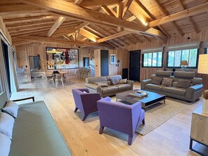 A spacious living area with wooden beams, a dining area, and a large window. - Stunning villa with pool - 8 guests (LE CANON)