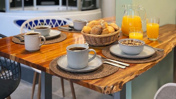 A breakfast table with coffee, pastries, and orange juice. - Modern SPA studio in the heart of Gehrden (Gehrden)