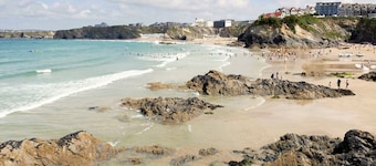 1 Golden Bay is a stylish ground floor apartment offering sea glimpses