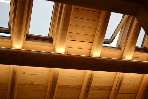 Un plafond en bois agrémenté de lucarnes.