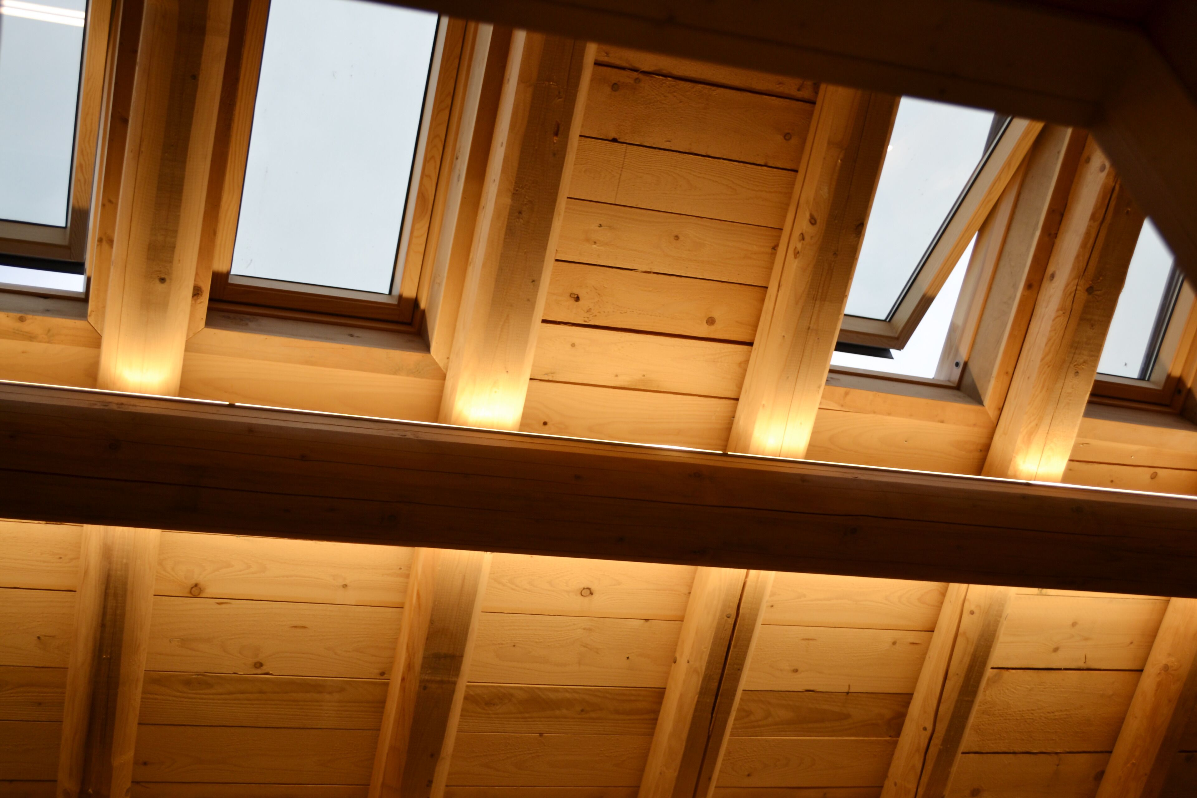 A wooden ceiling with skylights.