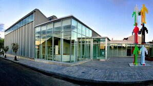Un bâtiment moderne doté de grandes fenêtres en verre et d’un toit plat.
