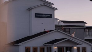 A white building with a sign reading 'Harborline Hotel.'