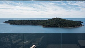 A view of a coastal landscape with two small islands, a clear sky, and calm water. - DUBROVNIK VISTA RESIDENCE by DuHomes  (Dubrovnik)
