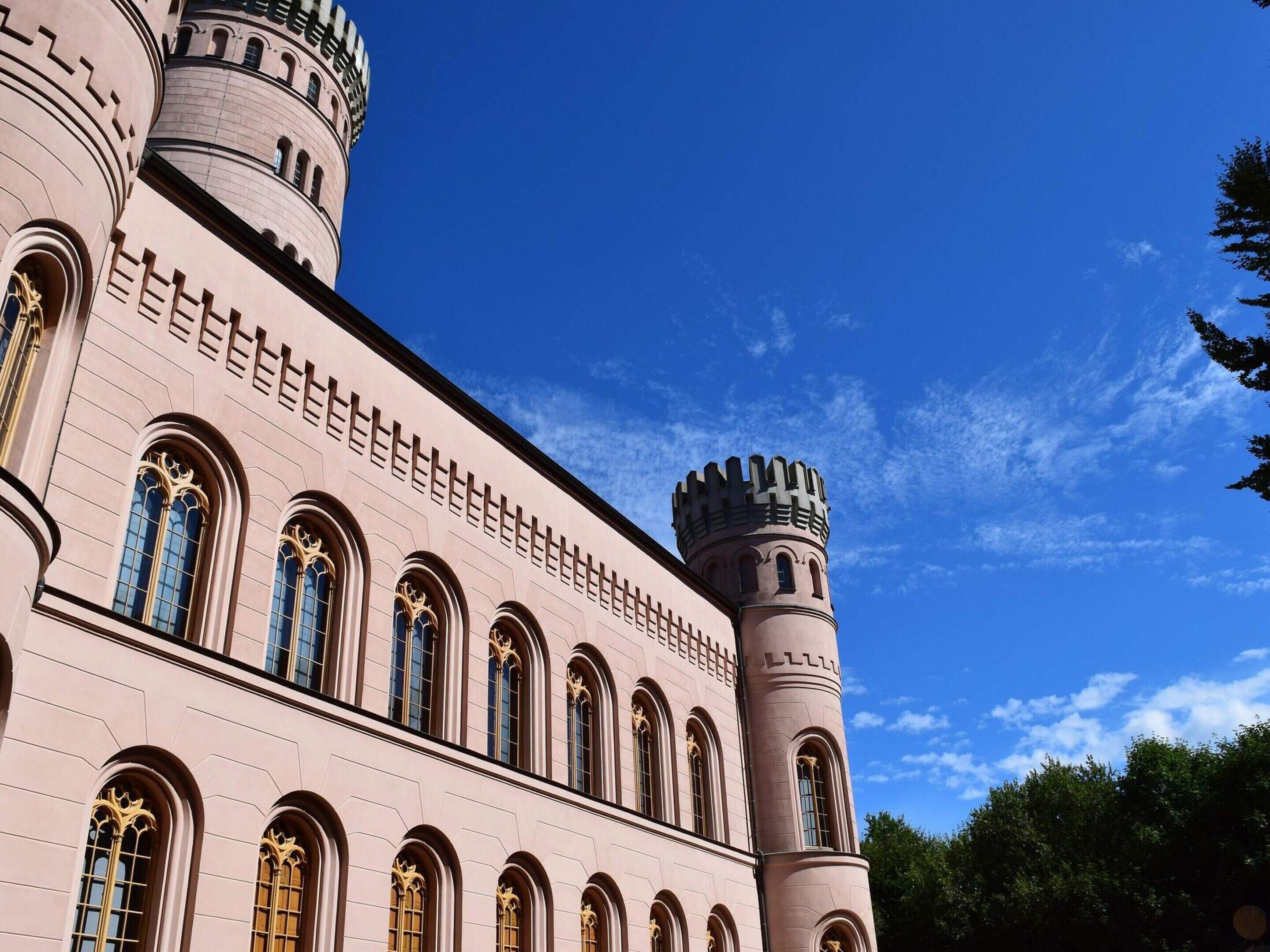 A large building with arched windows and two towers.