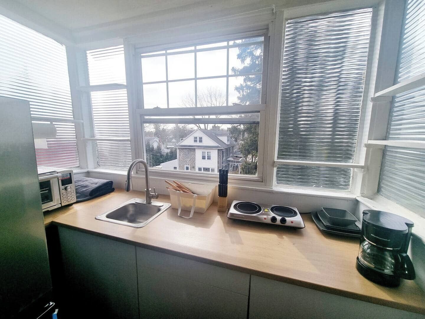 Step into a well-appointed kitchen designed for convenience. It includes a full-sized refrigerator, range, space for meal prep, and dining table. You'll find generous storage in the cabinetry, making it easy to keep things organized.
