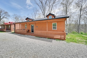 A wooden cabin with a porch, a door, and a window. - Lake Cumberland Views! Boating & Fishing Basecamp (Somerset)