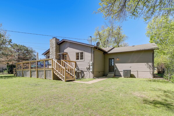 A two-story house with a covered porch, a chimney, and a small front yard. - Midtown Tulsa Gem w/ MCM Decor: Private Deck, Yard (Tulsa)