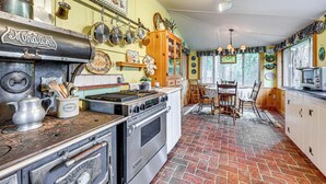 A kitchen with a stove, oven, and various utensils. - Gateway to Sequoia Natl! Rustic Cabin w/ Patio (Camp Nelson)