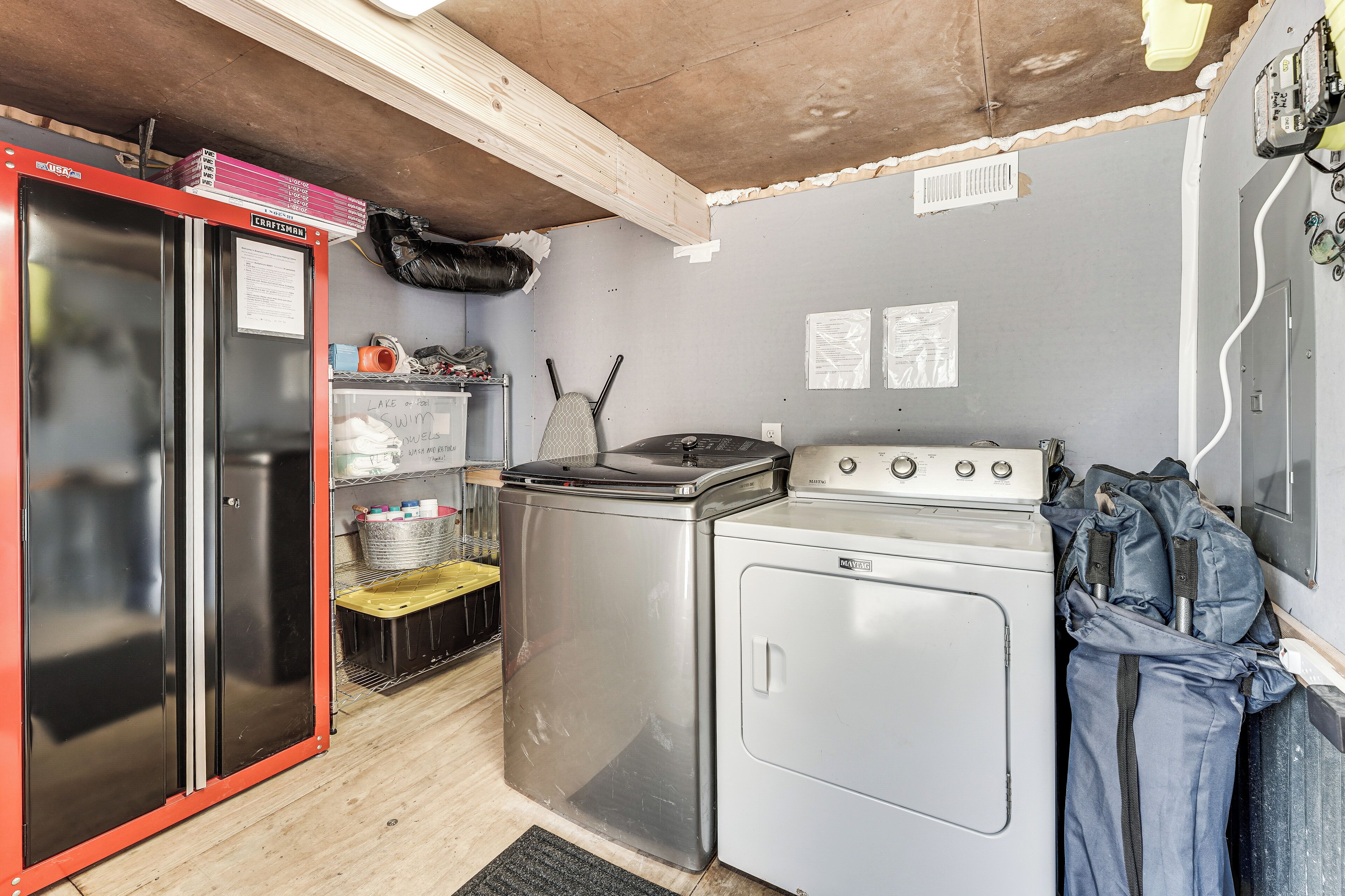 A compact kitchen with a refrigerator, washing machine, and stove.