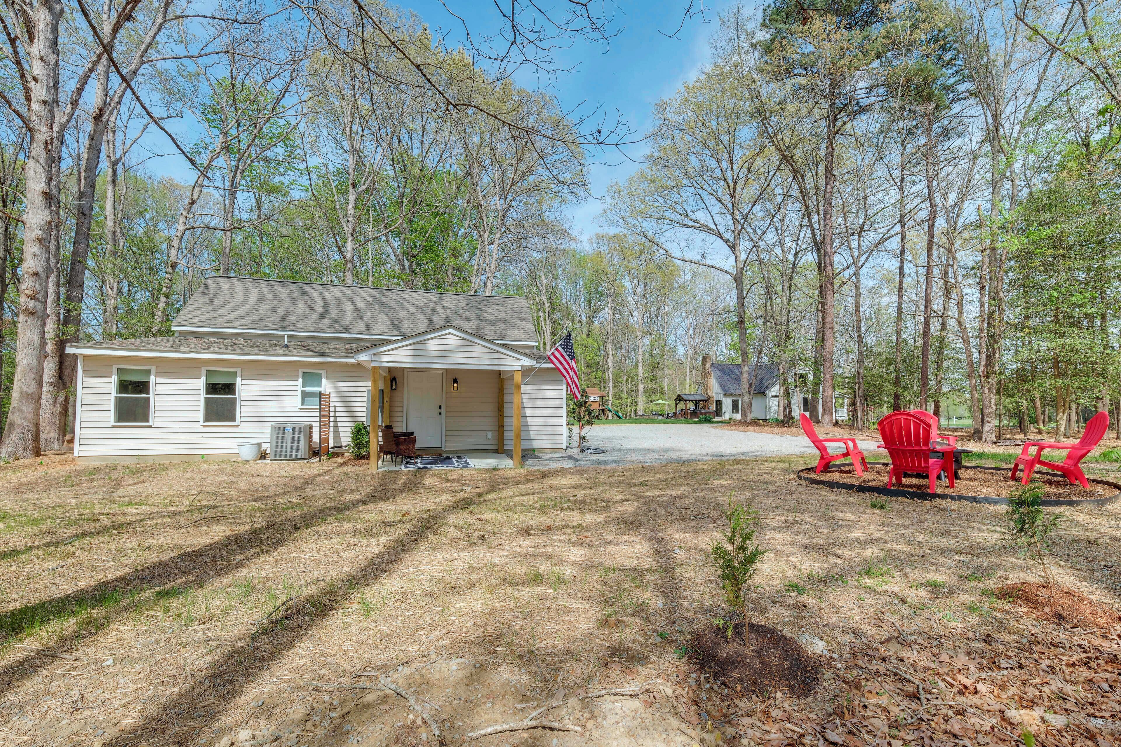 A single-story house with a garage, a small porch, and a flag.