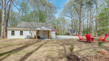A single-story house with a garage, a small porch, and a flag.
