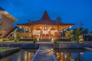 A building with a covered patio, a pool, and a staircase leading to the entrance. - Dauh Nyuh (Mas)