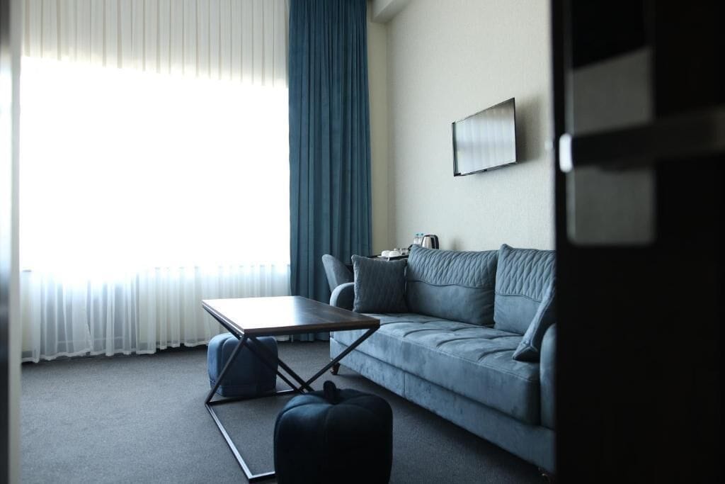 A modern living room with a sofa, a coffee table, and a small side table.