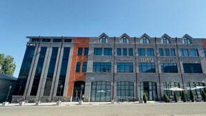 A multi-story hotel with a modern design, featuring large windows and a prominent 'BMG Hotel' sign. - BMG Hotel  (Goris)