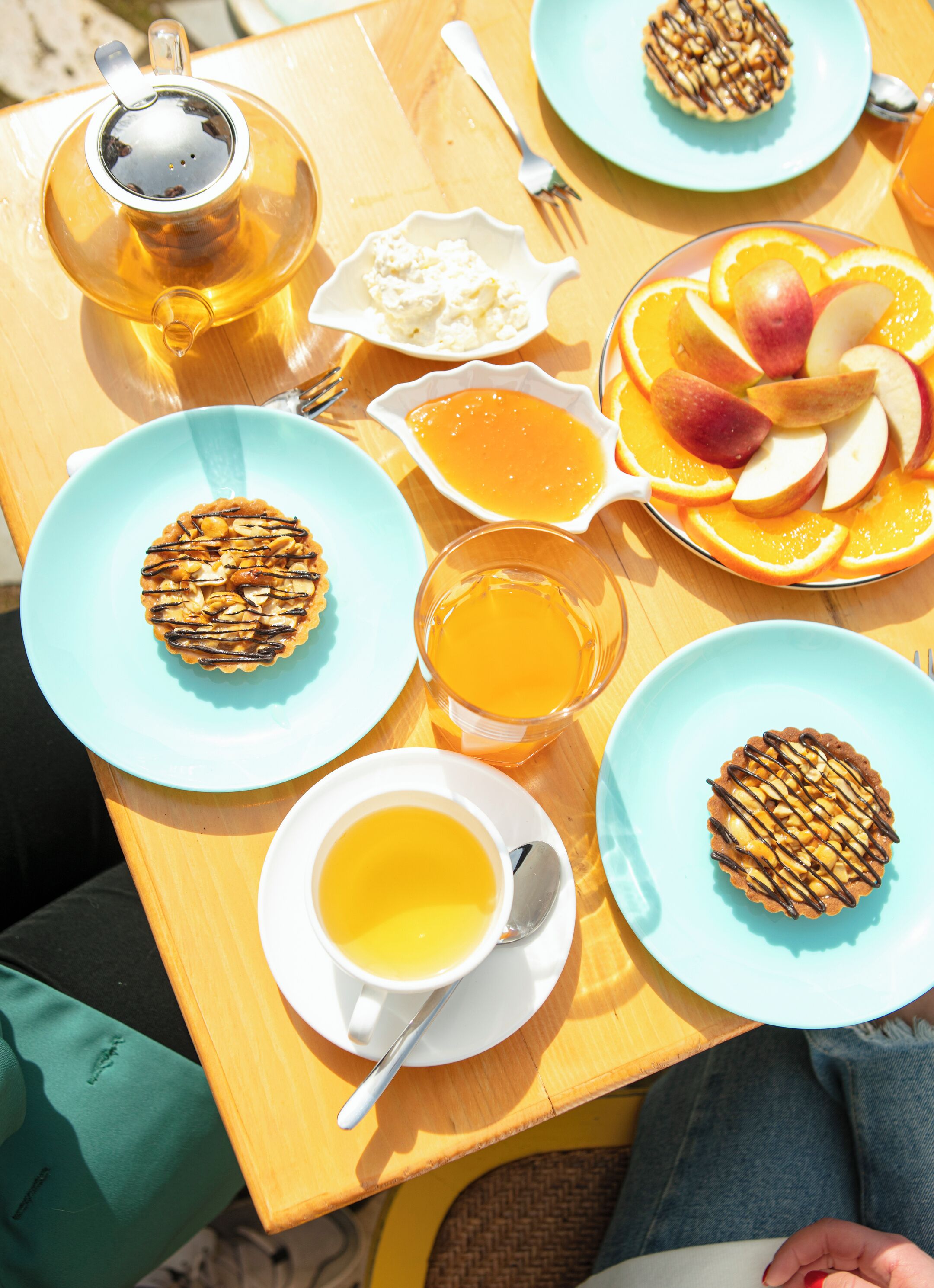 A table with breakfast items including pastries, fruit, and beverages.