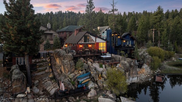 A lakeside lodge with multiple cabins, a dock, and a stone pathway.