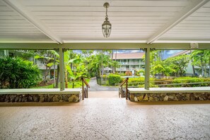 A covered walkway leading to a building with a 'NO ALCOHOLIC BEVERAGES' sign. - Big Island Kona Islander #347 Condo (Kailua-Kona)