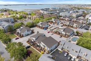 A residential area with detached houses, a parking lot, and a view of the water. - Club Ocean Villas 63 (Ocean City)