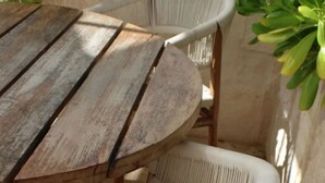 A round wooden table with four white wicker chairs. - Tulum Paradise | 4BR Home with Private Pool (Tulum)