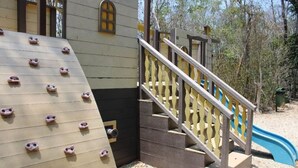 A playground with climbing holds, a slide, and a staircase. - Tulum Paradise | 4BR Home with Private Pool (Tulum)