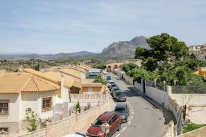 A street lined with parked cars and buildings with tiled roofs. - Holiday Home 'Dawn Of Busot' with Private Terrace, Garden and Wi-Fi (Busot)