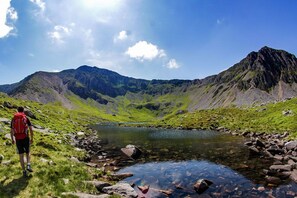 A hiker on a trail with a mountain and a lake in the background. - Elegant 18th Century Country House with Cader Idris views | Cefn-Y-Maes (Brithdir)