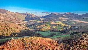A panoramic view of a mountainous landscape with rolling hills and a valley. - Lovingly renovated barn near the Lon Goed | Llwyn-Y-Forwyn (Chwilog)