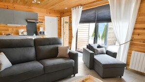 A modern living room with a grey sofa, a round coffee table, and a sectional sofa. - Chalet 'Le Ch'ti  Lecelles' with Private Terrace and Private Garden (Lecelles)
