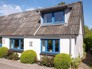 A white building with blue-framed windows and a corrugated metal roof. - 6 Person Holiday Home in Samso (Samsø)