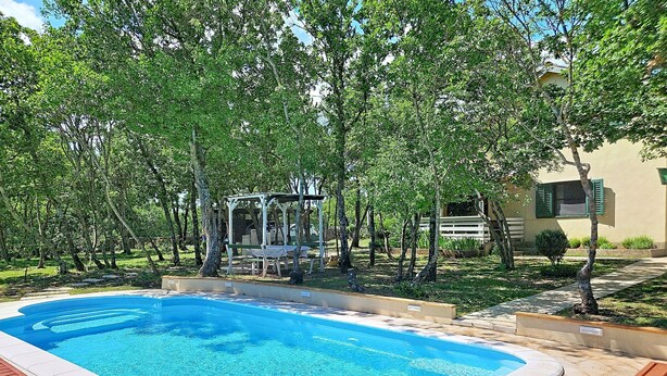 A swimming pool with a wooden deck, surrounded by trees and a gazebo. - Country pleasures cottage by Interhome (Dugopolje)