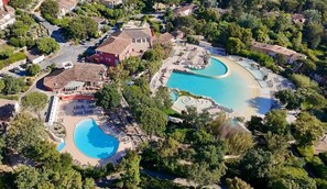 An aerial view of a resort with two large swimming pools, a central building, and surrounding greenery. - VILLA GRIMAUD "DOMAINE LES RESTANQUES" WITH SWIMMING POOL 2 KMS FROM THE BEACHES (Grimaud)