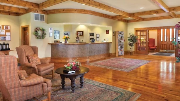 A lobby with wooden beams, a reception desk, and seating areas. - WorldMark Galena 2br (Galena)