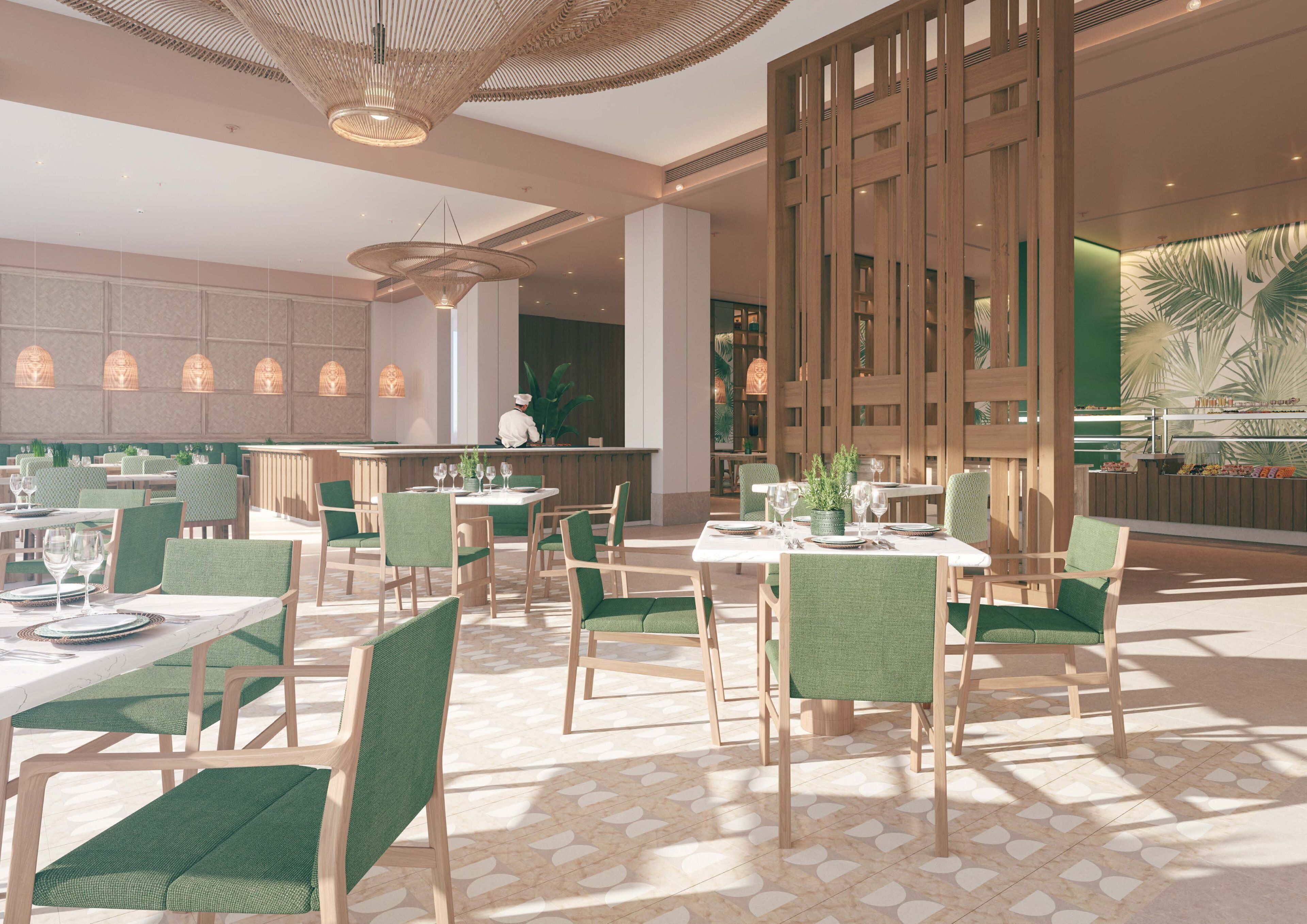 A modern restaurant with green upholstered chairs, marble tables, and a central bar area.