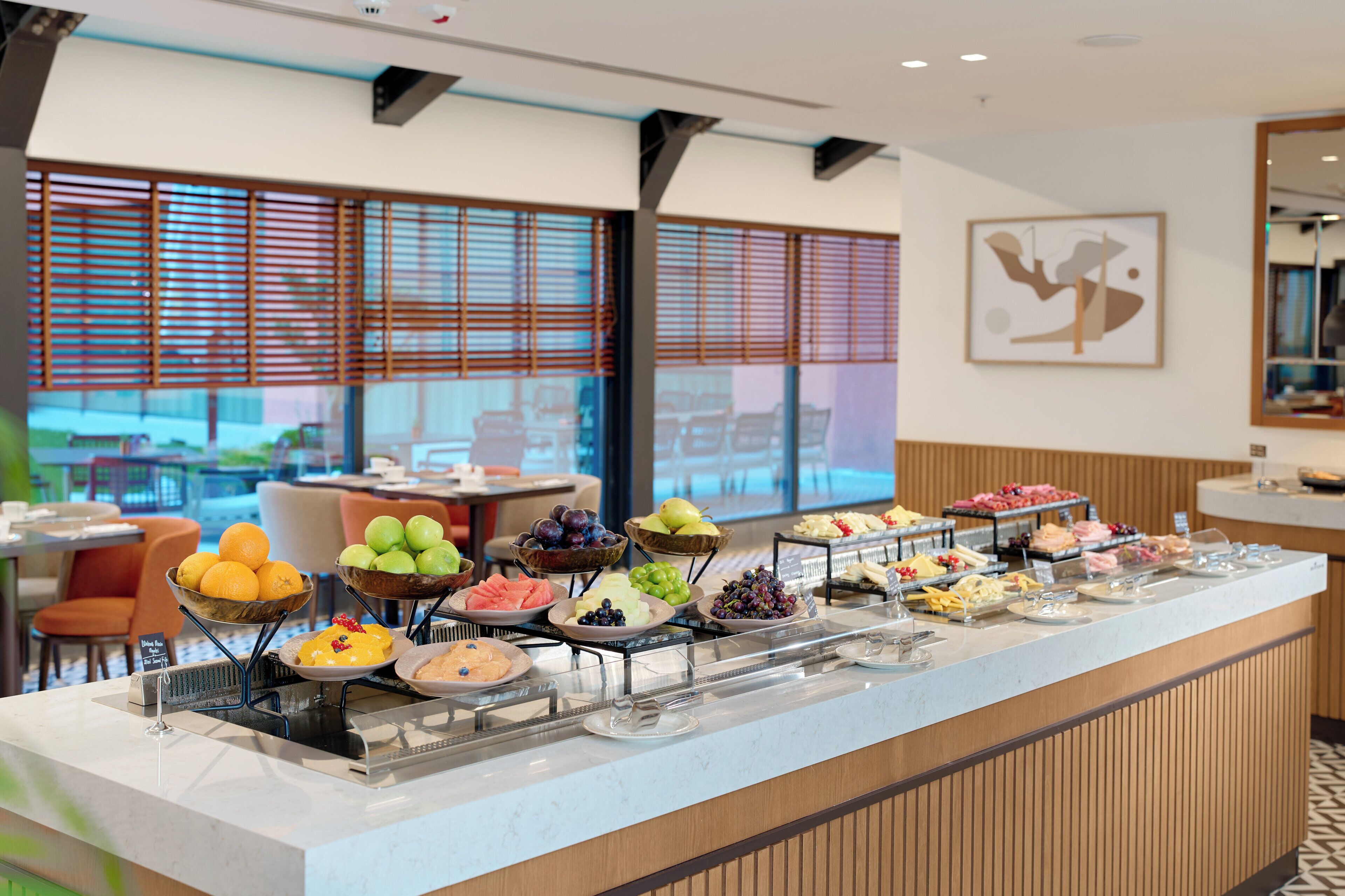 A buffet with various fruits and cheeses.