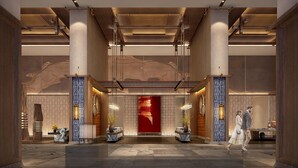 A spacious lobby with high ceilings, large columns, and a central red accent wall. - Hualuxe Guiyang Financial City (Guiyang)