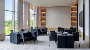 A conference room with tables, chairs, and a large screen. - Kimpton Nine Trees Shanghai By Ihg (Shanghai)